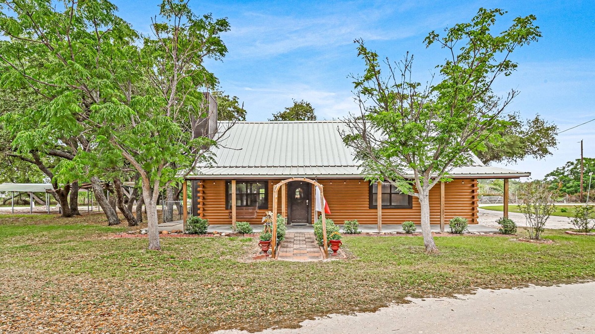 Rockport Cabin | 2-story cabin with an enclosed yard, patio, and large shade trees