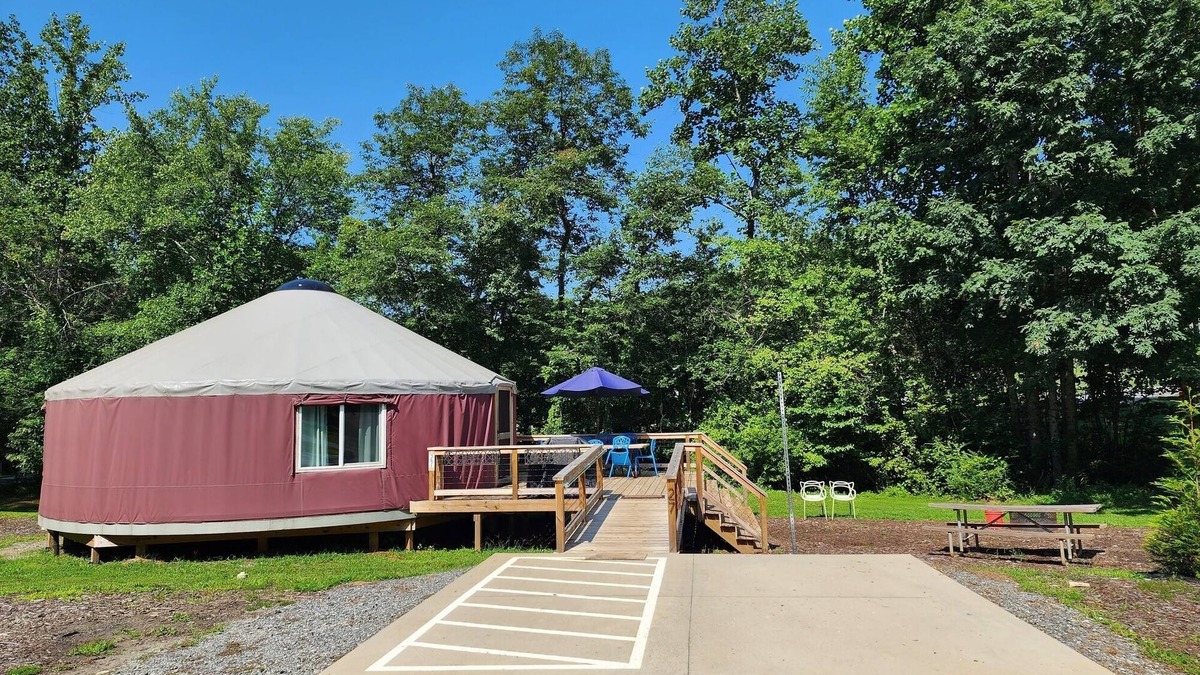 Mill Spring House | 30' ADA Yurt with a large deck, on the creek, full kitchen, dome skylight, dog friendly, 2 bedrooms, sleeps 5.