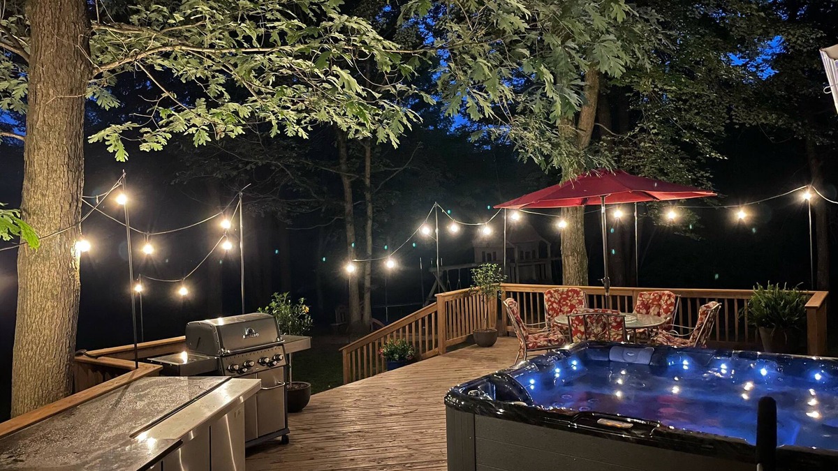 Waupaca House | A beautiful recently remodeled home nested on a wooded river lot with a hot tub.