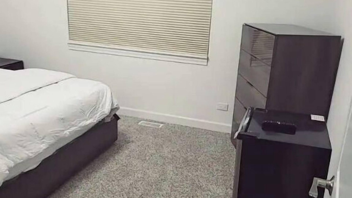 Oak Lawn House | A cozy bedroom in a home with high-tech amenities