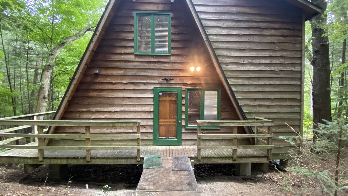 Allegan House | A-frame cabin nestled in forest, stunning lake view, perfect serenity.