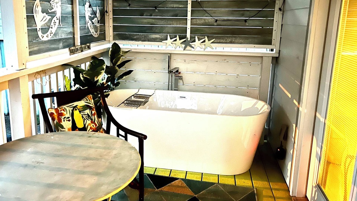 Gulfport House | After beach time come back to an outdoor soaking tub in privacy fenced back yard