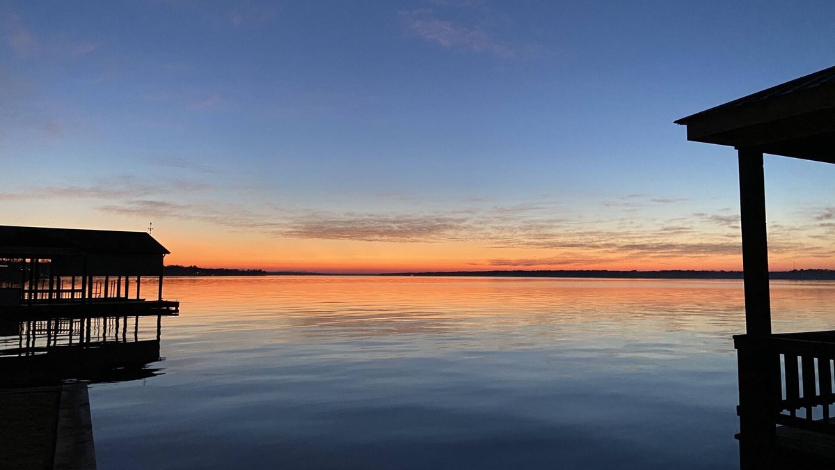 Dogwood House | Amazing sunsets at a lake front luxury home.