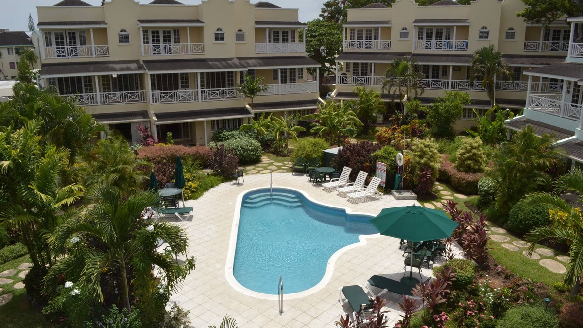 Marine Gardens Condo | Beautiful Condo with breezy Balcony Overlooking Pool & Garden – Steps to Beach