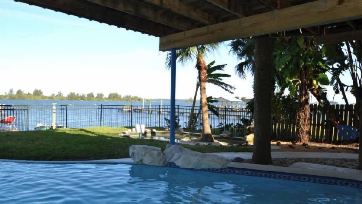 Grant-Valkaria Ski Chalet | Beautiful Riverfront Chalet w/Pool & Boat Dock- Old Florida Fun- Pet Friendly!