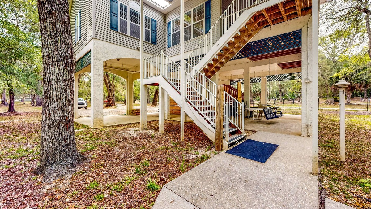 Bell House | Beautiful, waterfront log home with nature views, woodstove, balcony, & patio