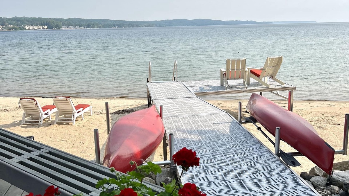 Suttons Bay House | Big Sandy Beach !Walk to Village! Suttons Bay Waterfront Cottage.