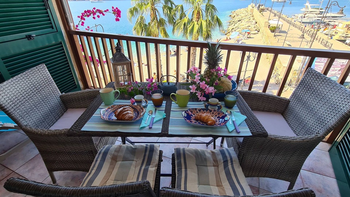 Porto Azzurro Apartment | Blue harbor lovely apartment with terrace above the beach.