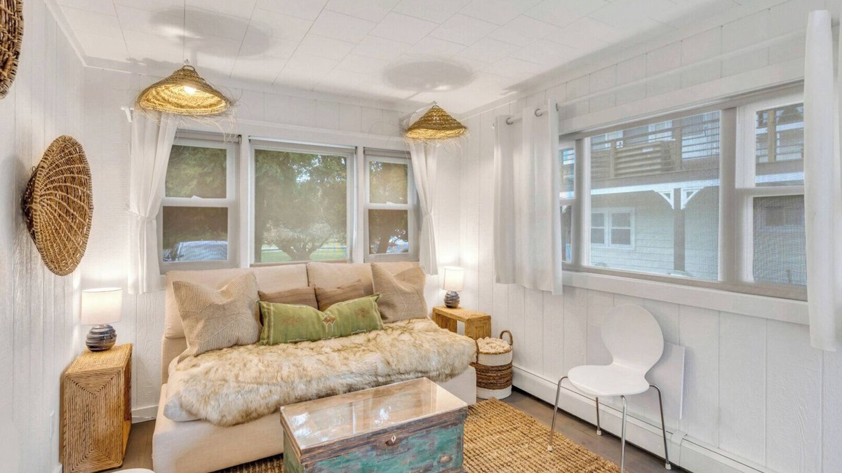 Montauk House | Bohemian-style hotel unit with ample natural light, a cozy seating area,.