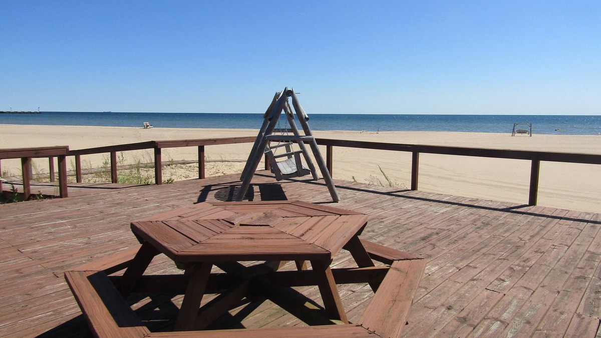 Au Sable Condo | Carpe Diem 365 located on Lake Huron sandy beach!