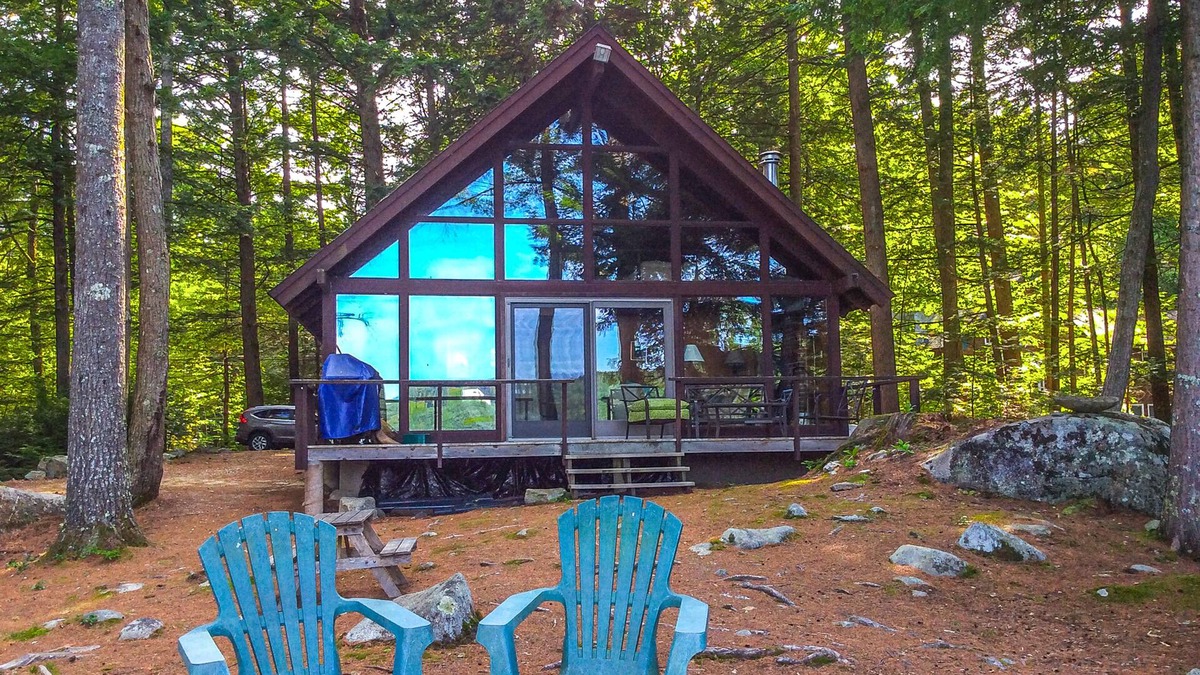 Meredith Cottage | Chalet-style lakefront home with private dock, beach, kayak, canoe & epic view