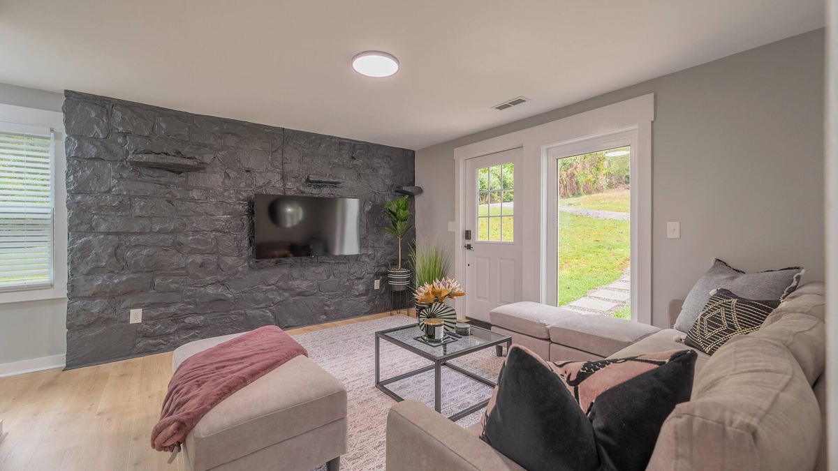 Blacksburg House | Charming entry and spacious back deck surrounded by nature, perfect for a peaceful getaway.