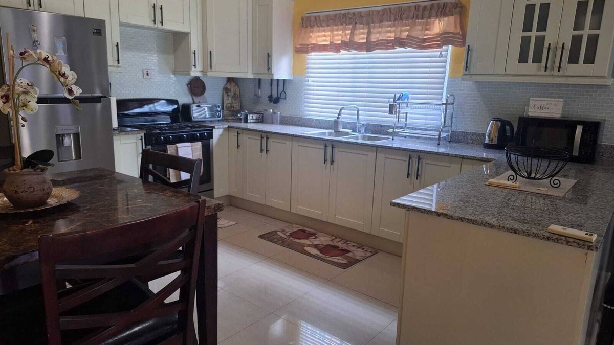 Spanish Town House | Charming sanctuary in the picturesque Caymanas Estates area.