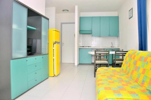 Bibione Pineda Apartment | Colourful seaside flat with pool on the rooftop