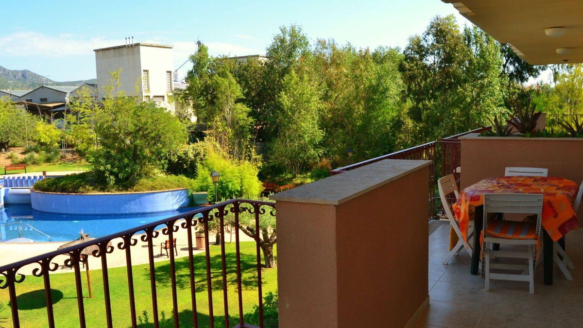 Sant Carles de la Rapita Apartment | Cosy apartment for 3 people with pool, A/C, TV, balcony and parking