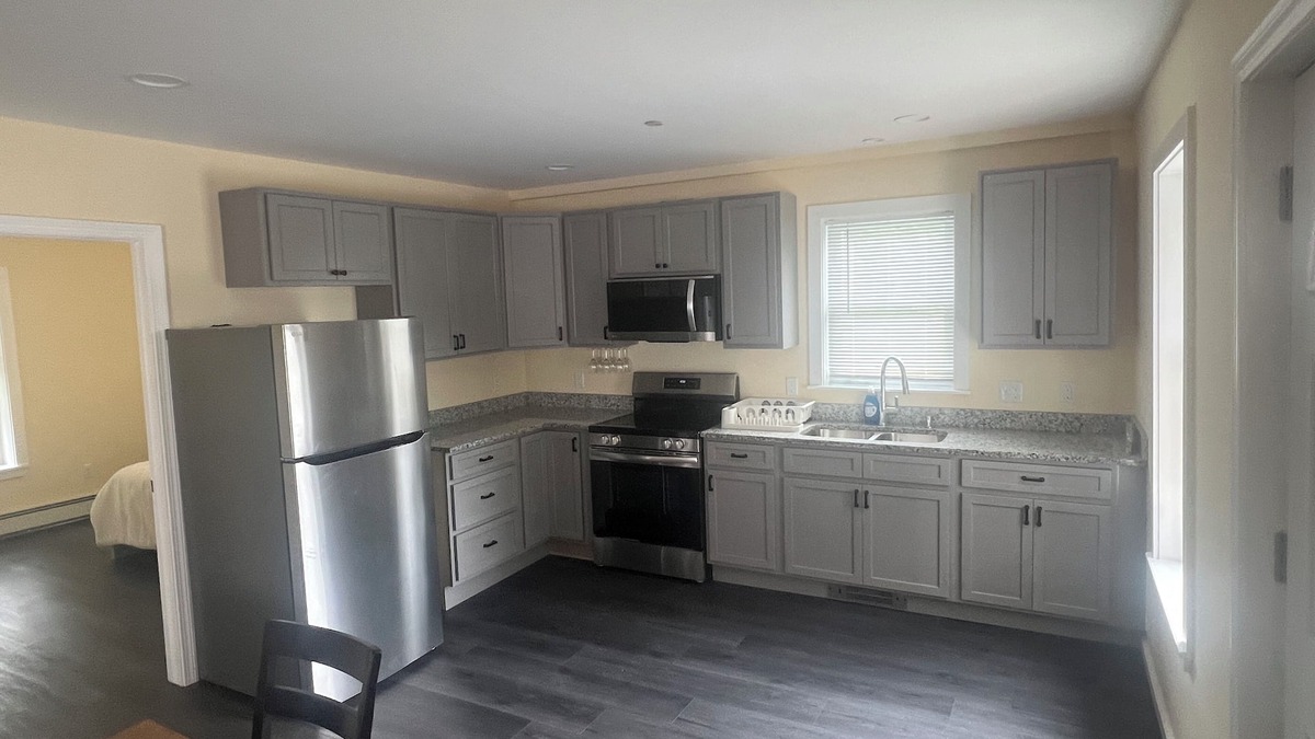 Guild Apartment | Cozy 2-bedroom apt-1 in Lakes Region with AC, WiFi, Pet friendly 2 queen beds