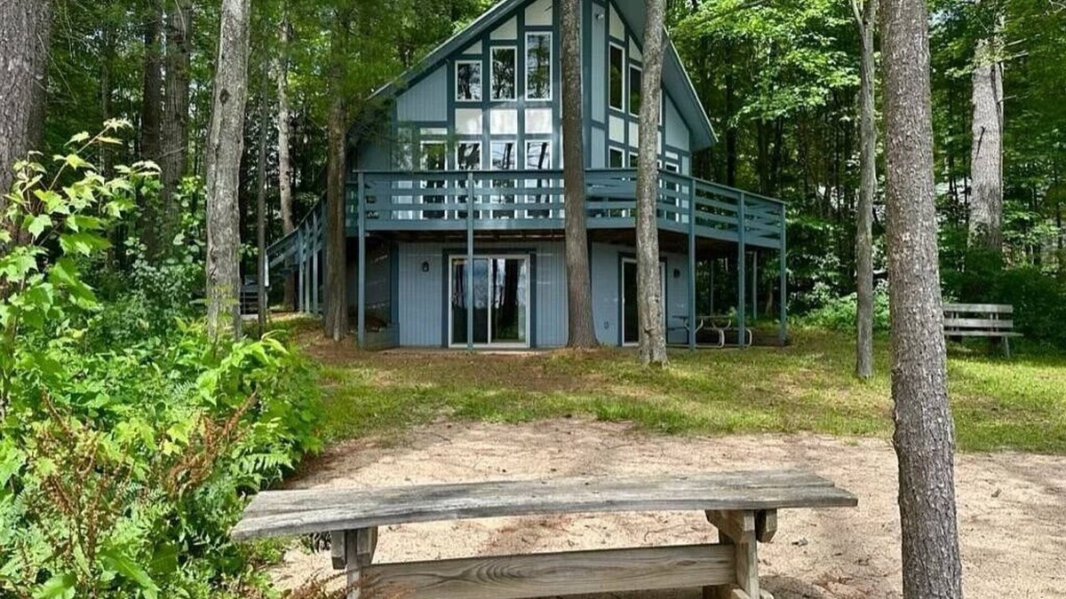 Elmira Cottage | Cozy beachfront cottage in the woods with walkout basement and wrap-around porch