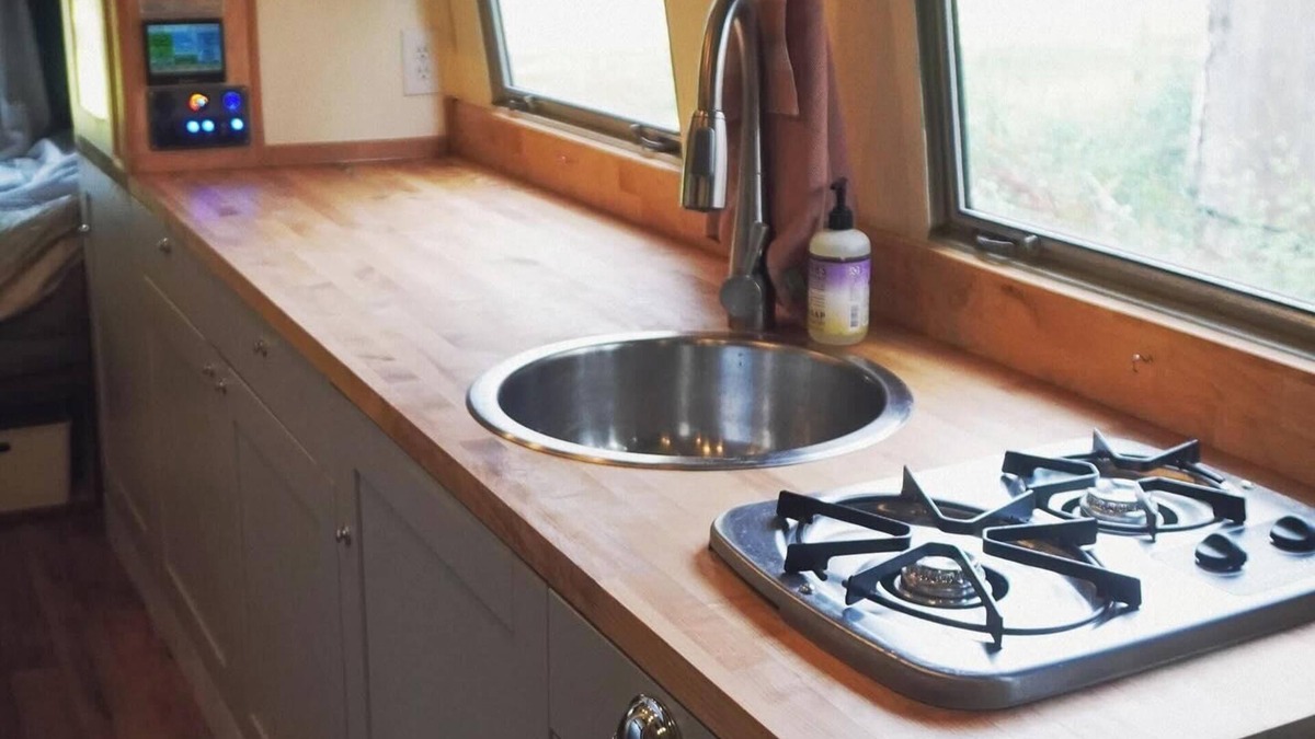 Larkspur House | Cozy camper by the creek, surrounded by serenity and nature.