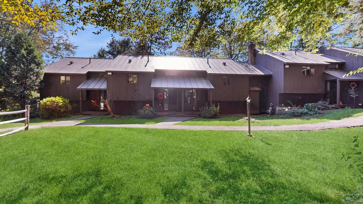 Quechee Condo | Cozy condo w/balcony, river view, electric woodstove, w/d, wifi, kitchen, a/c