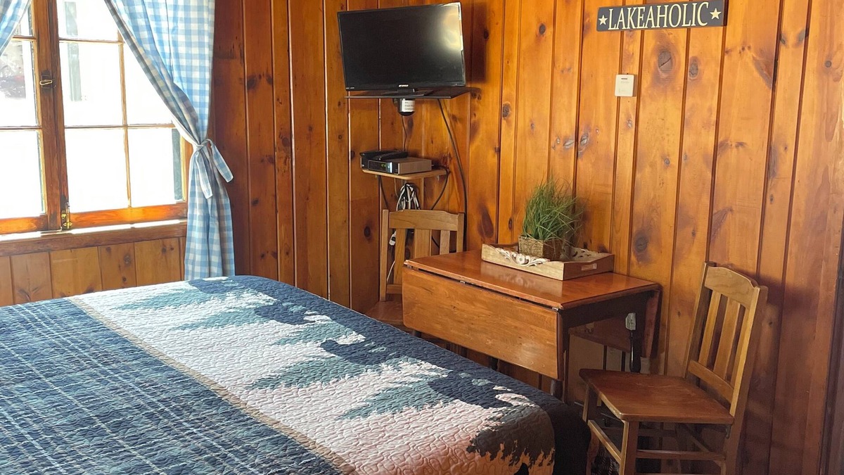 Itasca County Resort | Cozy queen bed in main Resort Lodge
