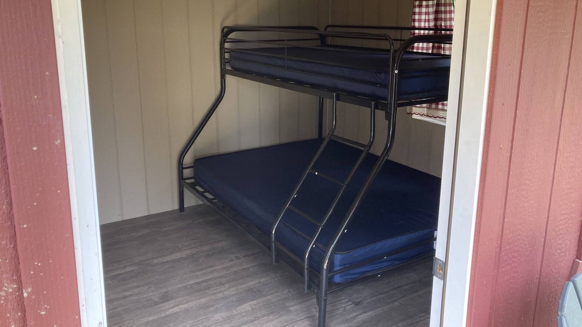 Front of Yonge RV Rental | Cozy solar Bunkie cabin located happy green acres campground
