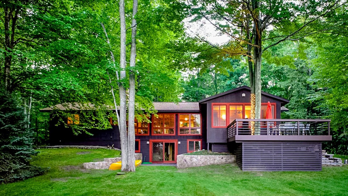 Lake Township House | Custom-designed lake house with screened porch, deck, Ping-Pong & lawn games