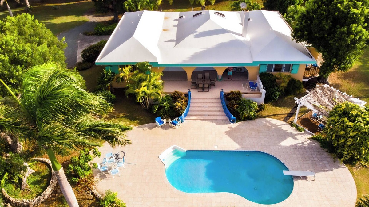Sion Farm House | Deja Blue Large pool and yard over looking the Carribean Ocean