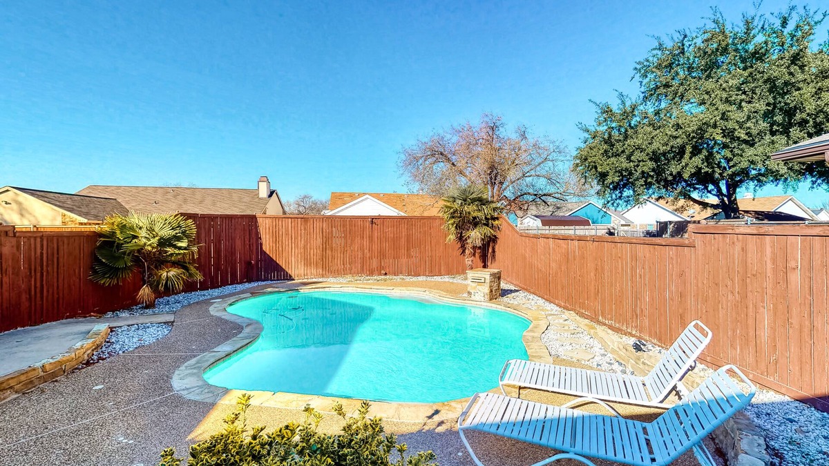 The Colony House | Dog-friendly remodeled home with full kitchen, outdoor pool, & arcade games