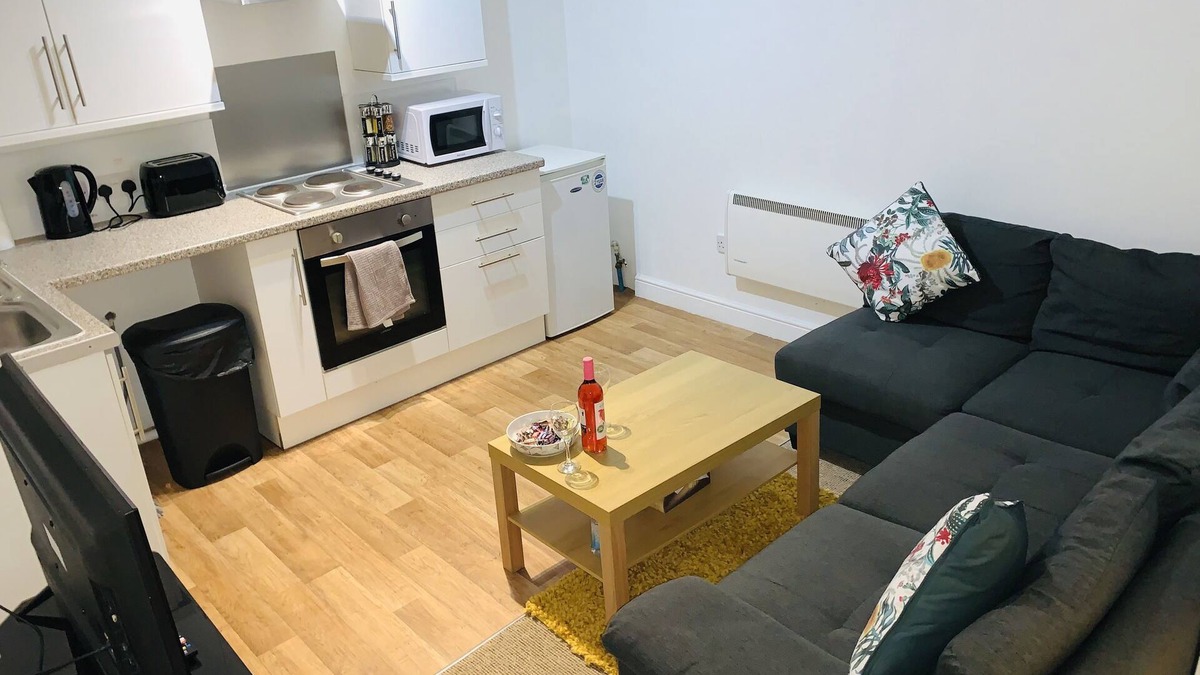 Wednesbury Apartment | Enjoy a spacious lounge with a cozy sofa bed and a private ensuite bedroom