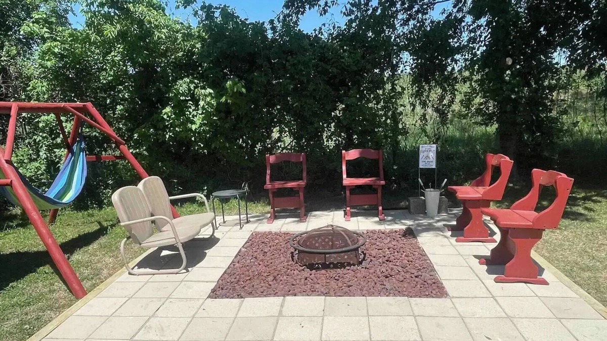 Dennis Cottage | Enjoy the river with a pool, firepit and a balcony with a gorgeous water view.