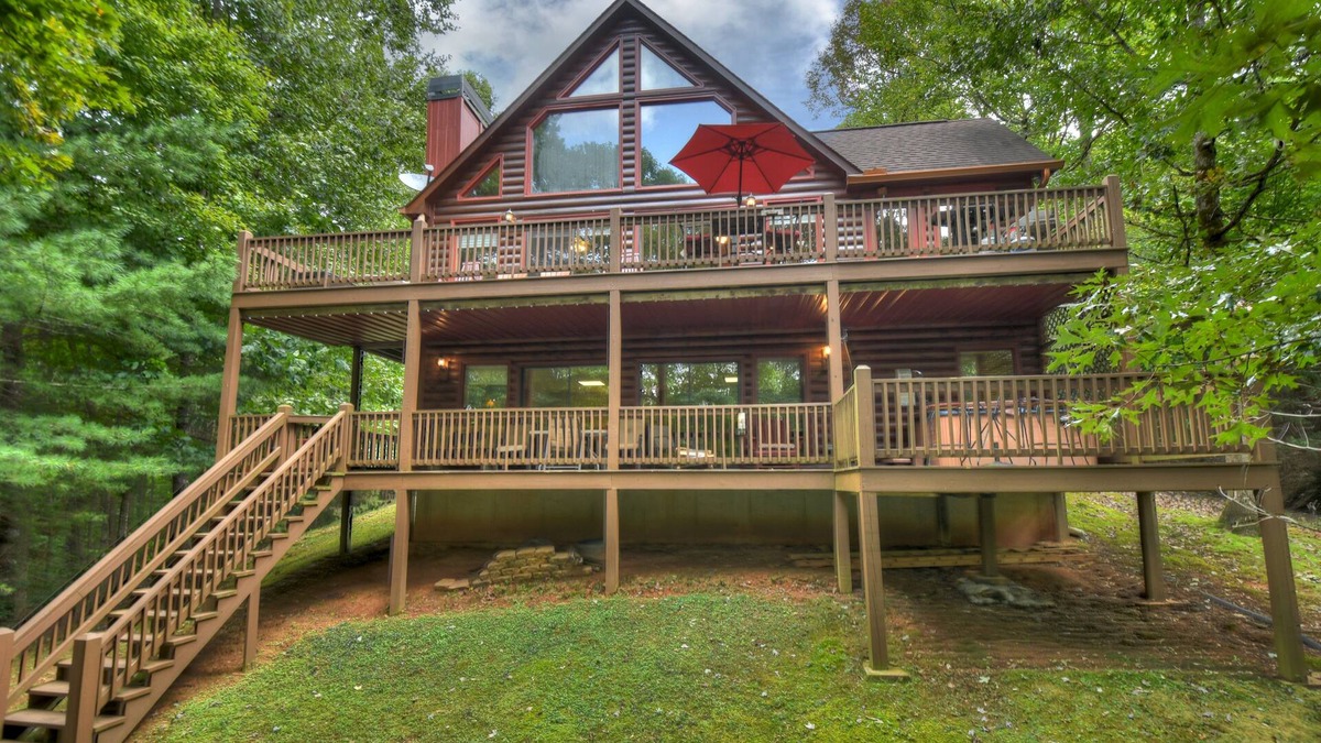 Walnut Mountain Cabin | Experience Lakeview Retreat, where pets are pampered by the shimmering waters. Unwind in a hot tub, enjoy WiFi, and a full game room w/pool table