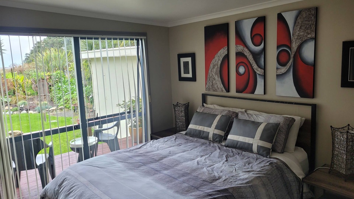 Collingwood Apartment | Great room with lovely view of the garden and beyond that Golden Bay
