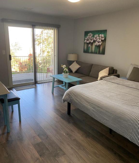Kamloops House | Guest suite with patio that backs onto greenbelt