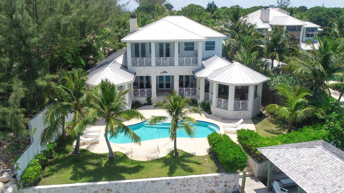 Dunmore Town House | Harbor Island Oceanfront Escape. Private Dock, Heated Pool & Sunset Views.