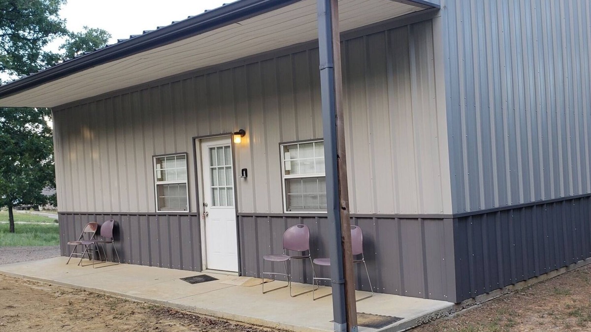 Sulphur House | Henson 2: Rustic 2 Bedroom Cabin surrounded by trees.