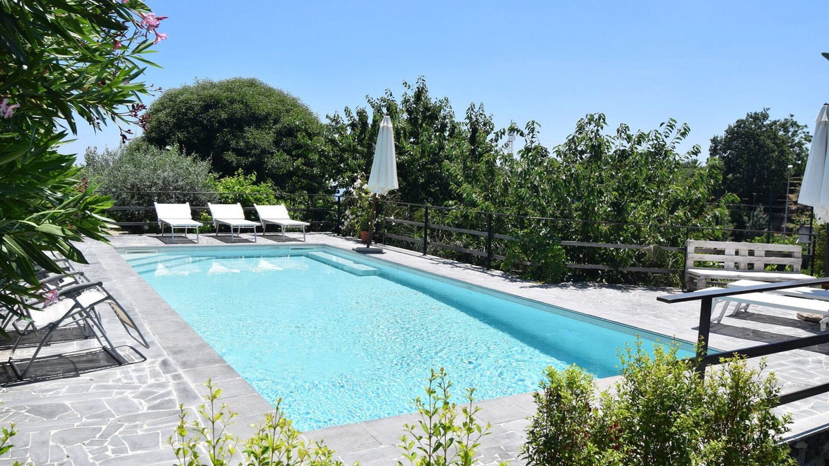 Santa Venerina Cottage | House surrounded by greenery surrounded by olive trees lemons oranges and chestnut trees