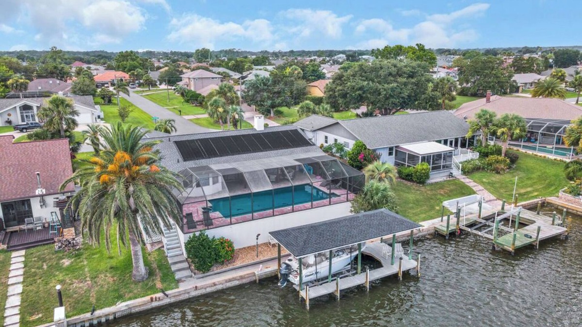Palm Harbor House | Huge Heated Saltwater Pool, Dock, Games & Waterfront Fun