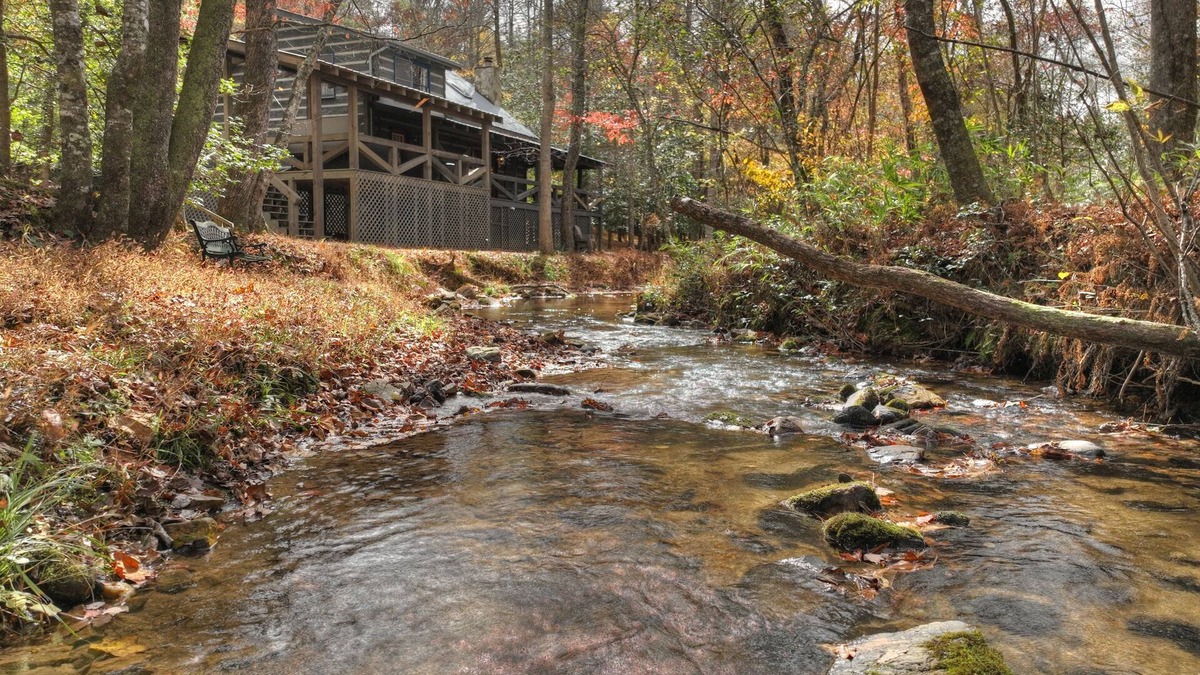 Dial Cabin | Indulge in "Just One More Night", a pet-friendly creekfront retreat boasting a spacious outdoor deck, hot tub, firepit, and WiFi