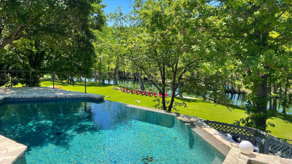 Hunt House | Inviting waterfront home with pool, patio, fireplace, W/D, & dog-friendly