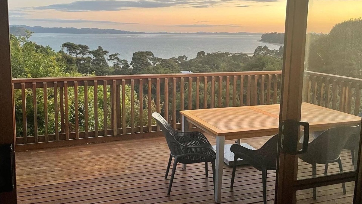 Orua Bay House | La Cachette is a charming Kiwi bach in native bush with stunning harbour views.