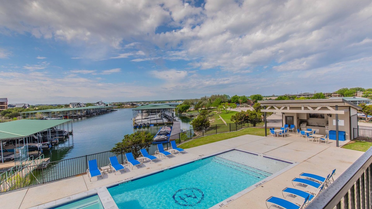 Graford Condo | Lake front Condo 2BD/2BA w/pool, hot tub, fire pit, gas grills, gym, & laundry.