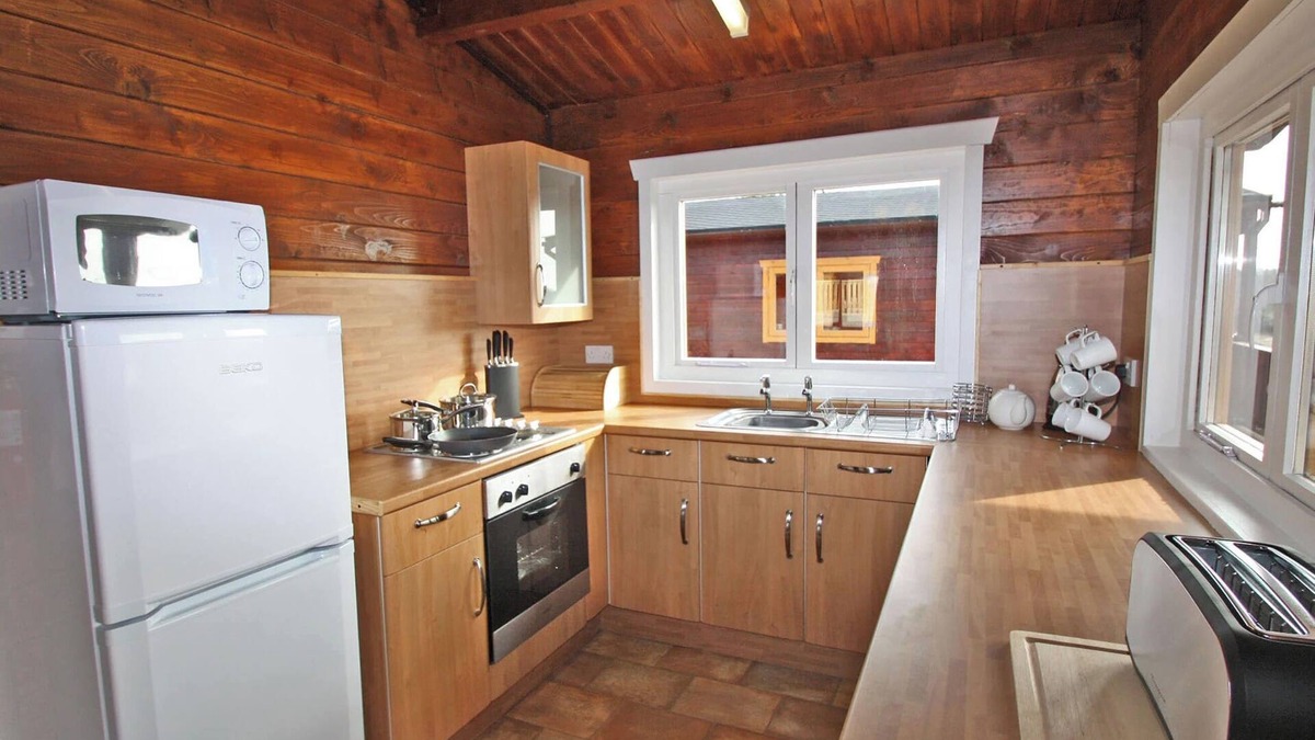 Pontardulais Cottage | Lake side log cabin peacefully situated and each enjoying fabulous lake views.