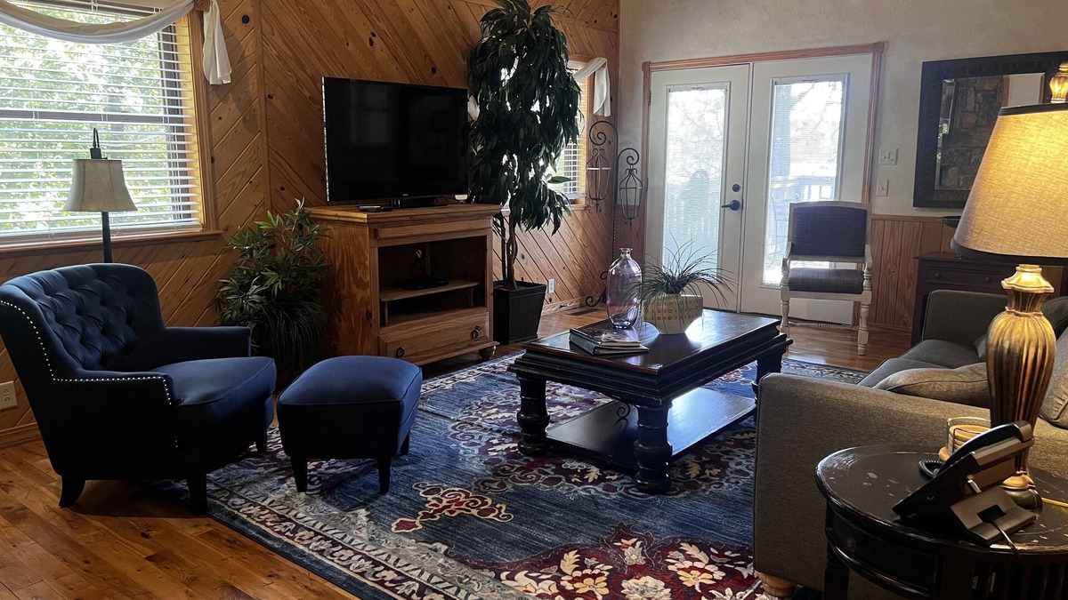 Mount Ida Cottage | Lake view two bedroom, two bath loft, log-sided cottage with private hot tub overlooking Lake Ouachita. by RedAwning