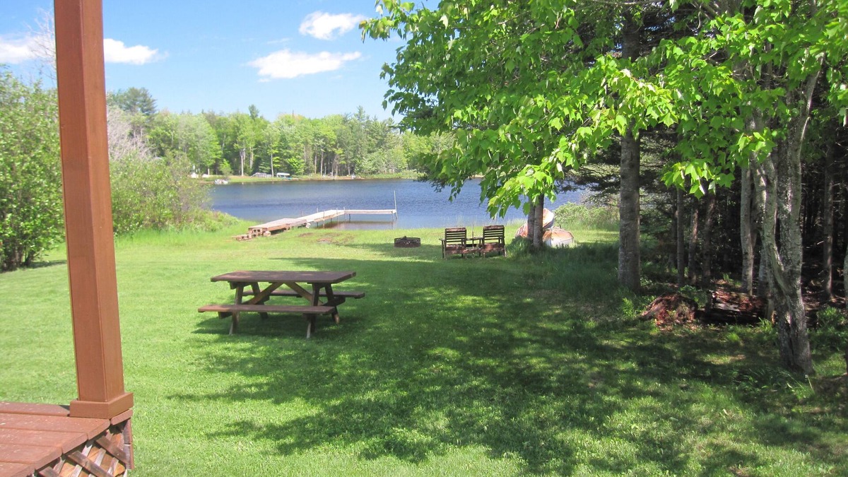 Wetmore Cottage | Lakefront, covered deck, huge backyard with grill, swimming, boat & kayaks!