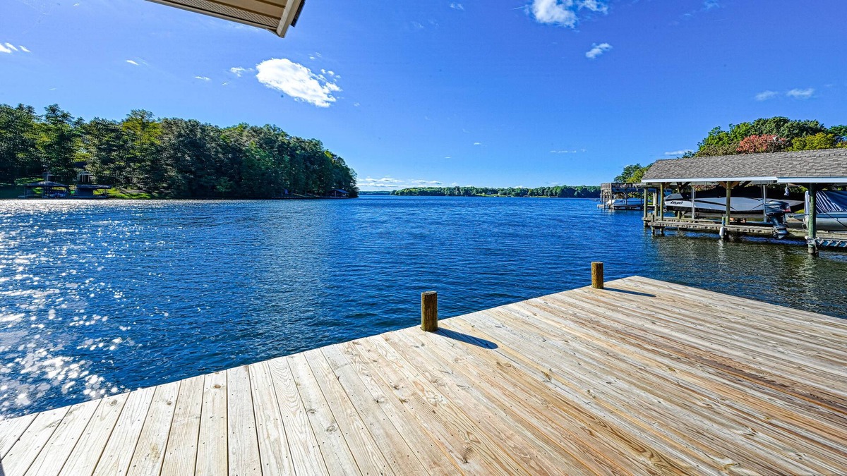 Bumpass House | Lakefront home with spacious deck, dock, game room, hot tub, & sunset views