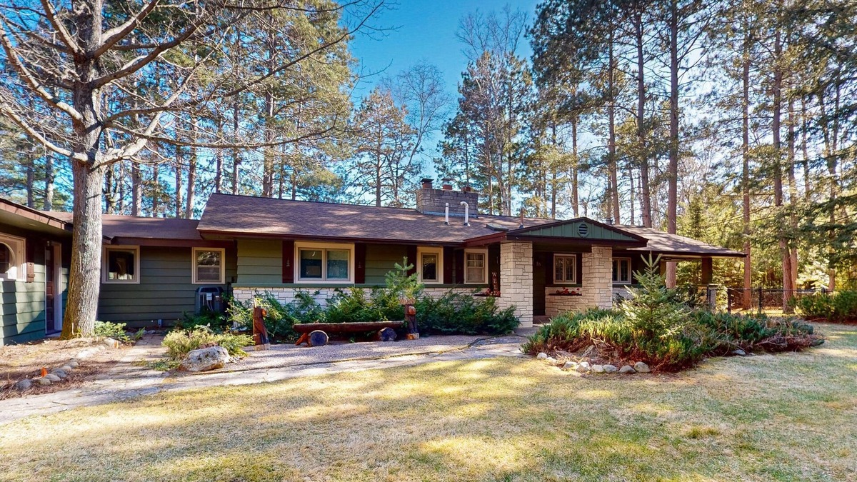 Lac du Flambeau House | Lakefront house with private covered hot tub, dock, wood fireplace, & firepit