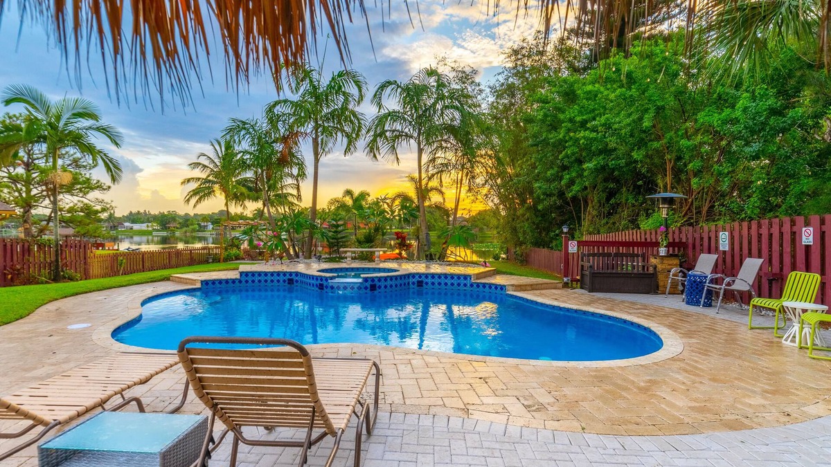 Lake Worth House | Lakefront Oasis 6BD, Sleep 14, Heated Pool, Tikis, Golf, Dock on Lake, No Stairs