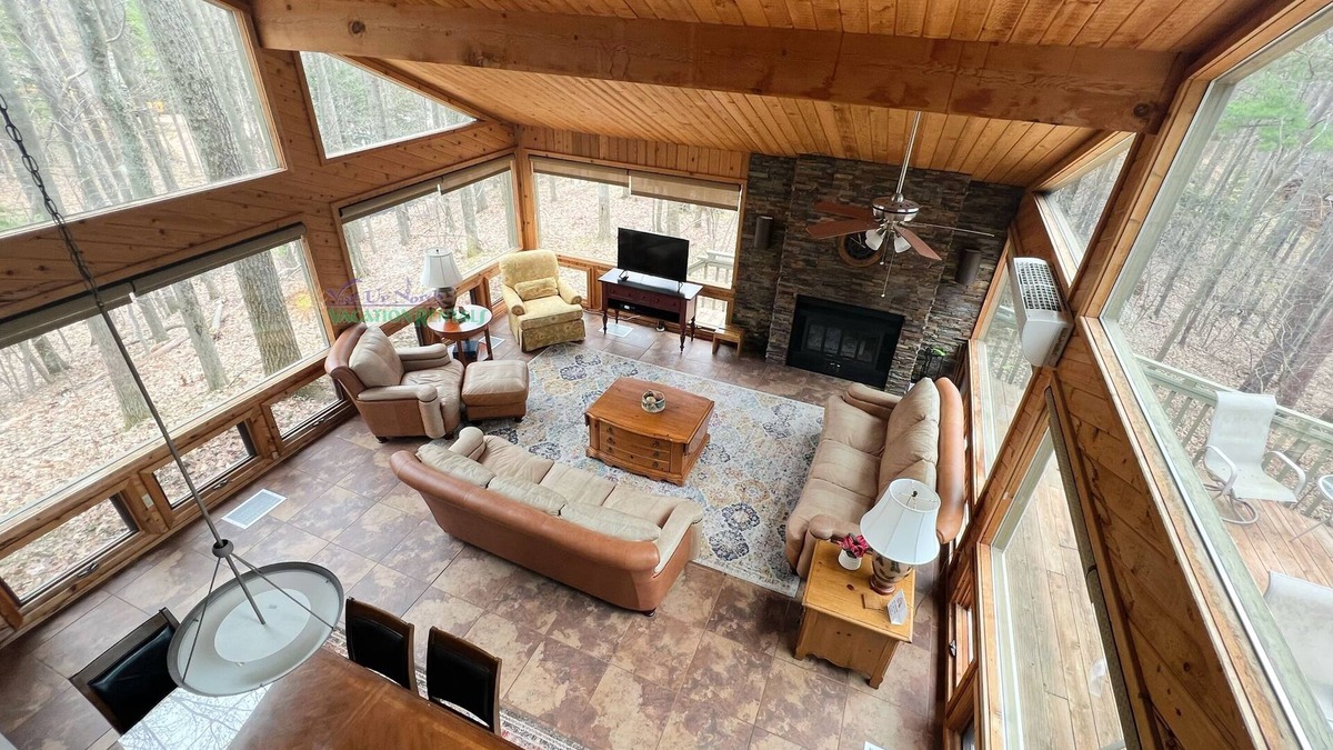 Maple City Cabin | Lodge-style multi-level home at the Homestead in Glen Arbor. Deck with grill.