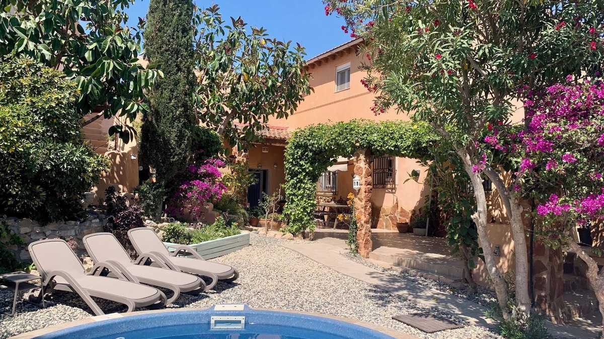 Los Vives House | Loma Alta; a unique 19th century cave house with lush garden and private pool