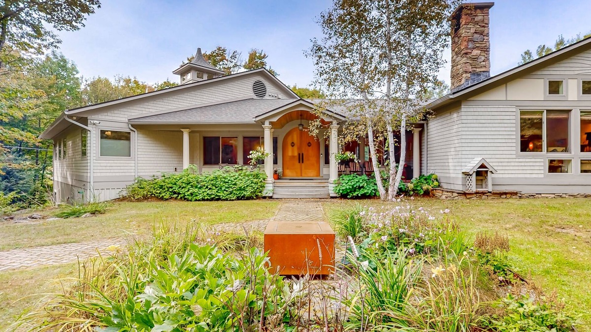 Warren House | Luxe custom home with hot tub, game room, & beautiful garden